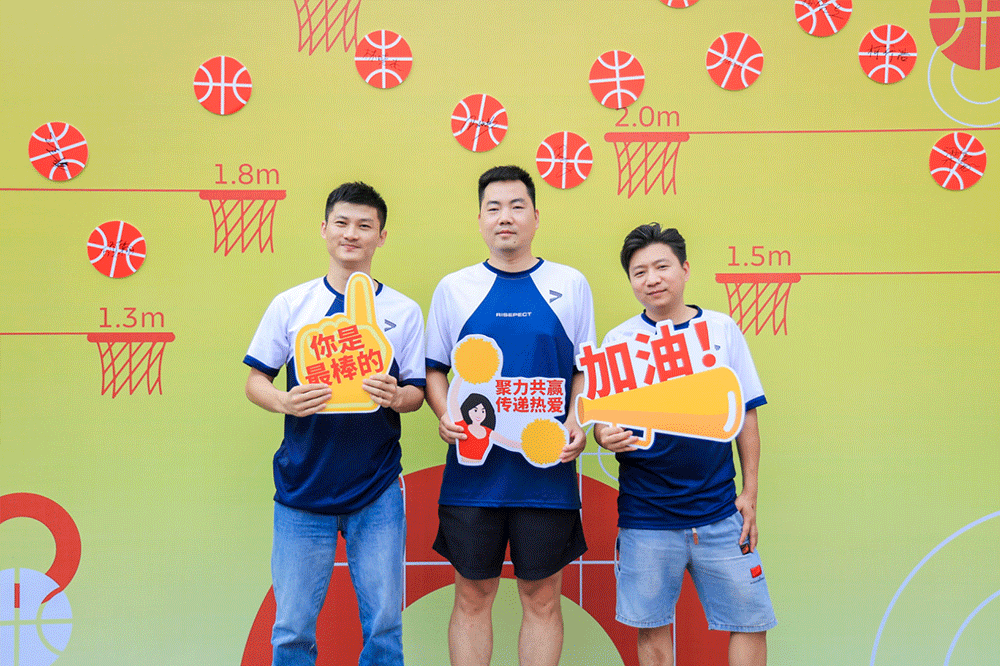 Rise employees who love basketball are taking a group photo at the basketball signature walls