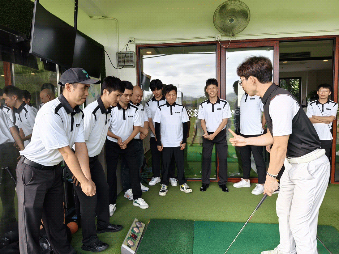 A male golf coach demonstrates golf grip and stance to male students of Rise Sportswear