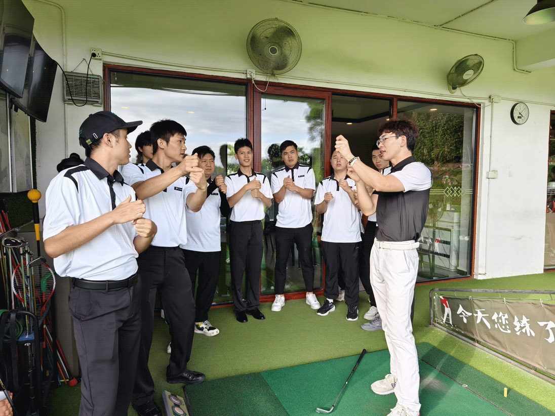 A male golf coach demonstrates golf grip to male students of Rise Sportswear