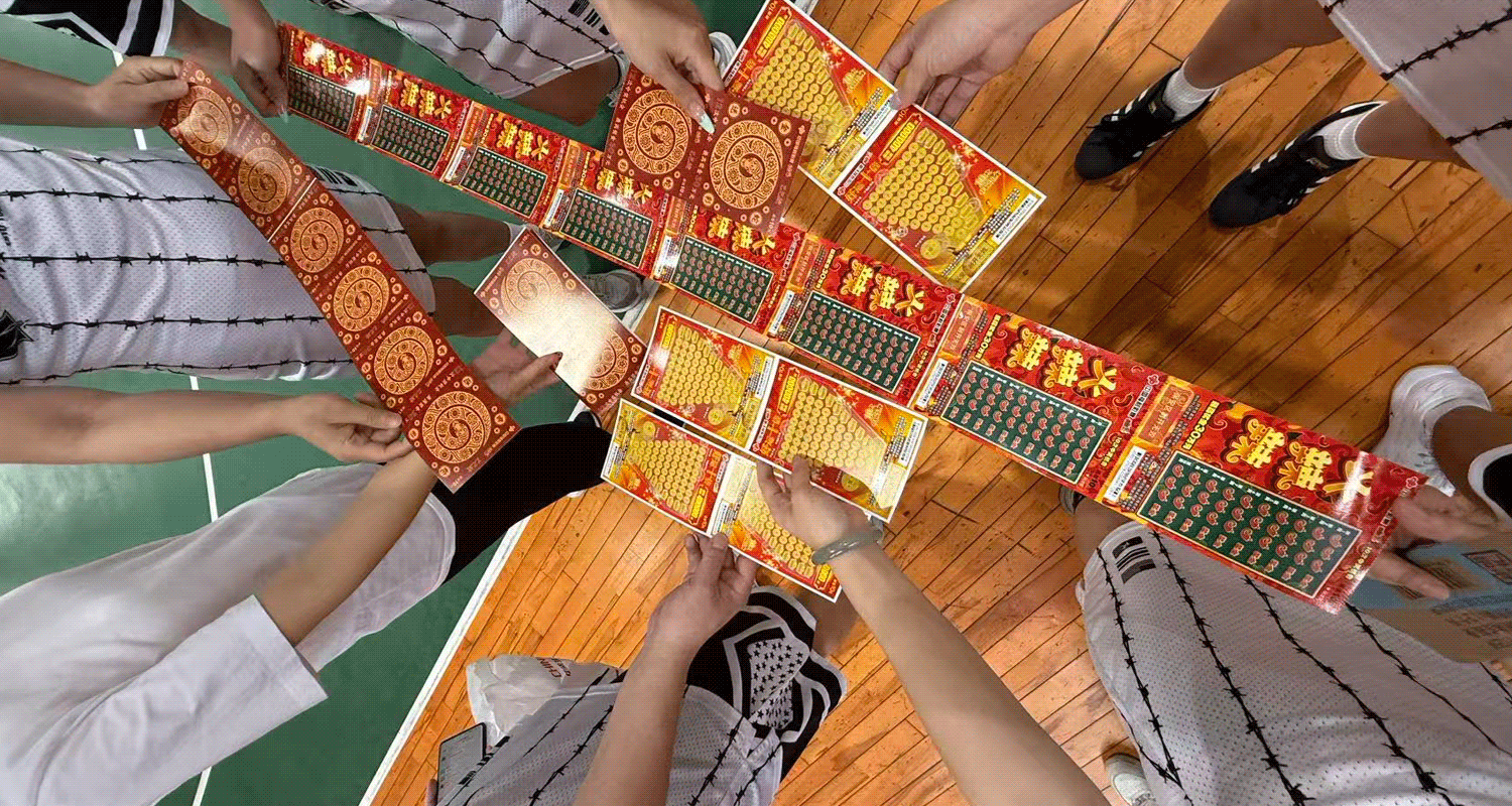 Close-up of several winning scratch-off tickets held up together for a group photo.