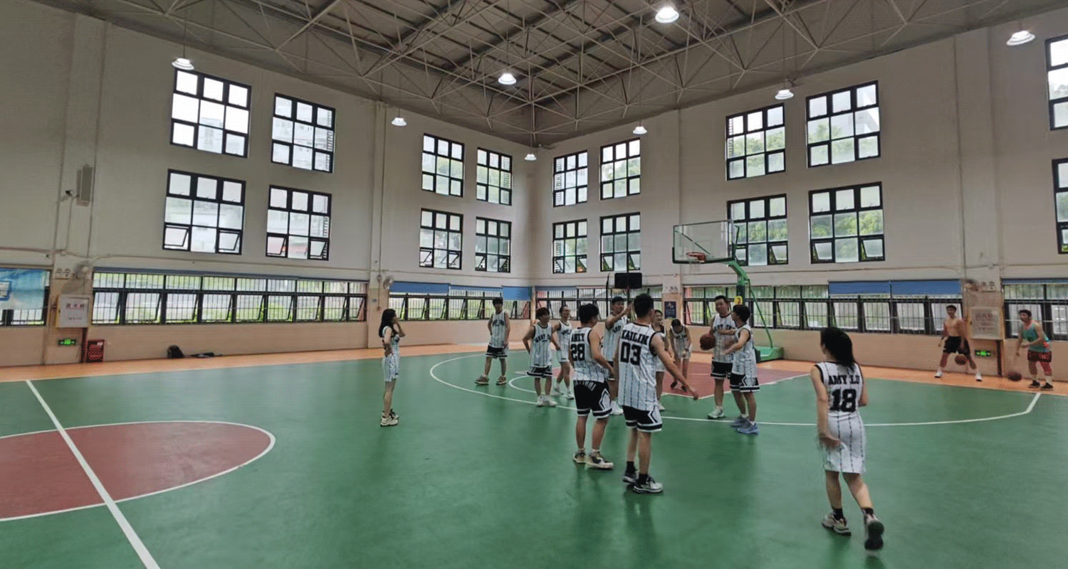 Wide shot of all participants from the RISE basketball group match, standing together on the court, capturing the unity and energy of the event.