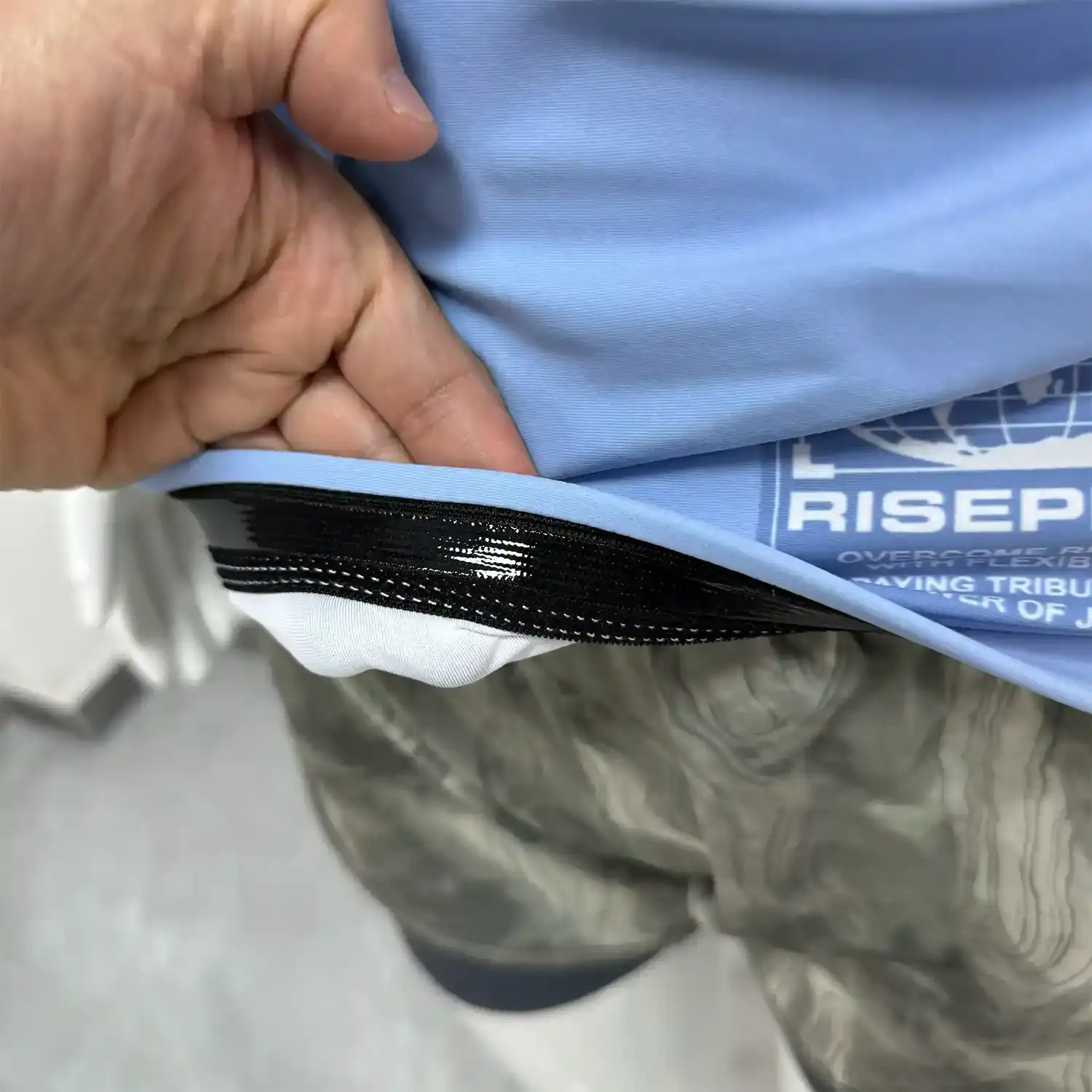 Women's light blue crack bjj rash guard long sleeve hem inside silicone strip details