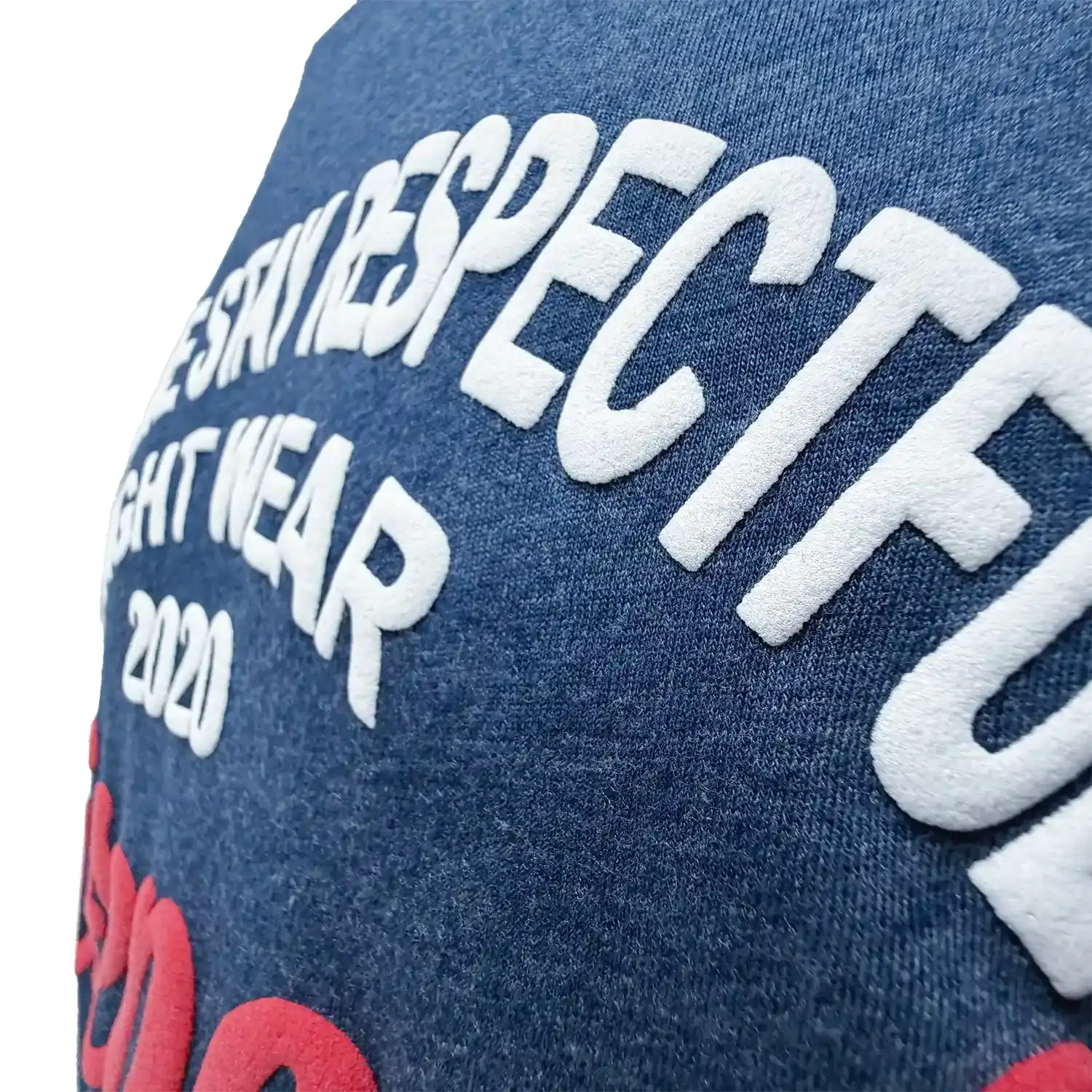 The close up 3D puff printing text of navy combat culture tee on chest
